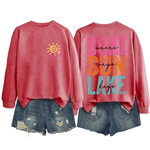 Detail of red boat sun lake waves sweatshirt paired with distressed denim shorts