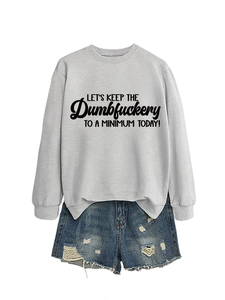 Flat lay of gray sweatshirt with slogan and distressed denim shorts ensemble