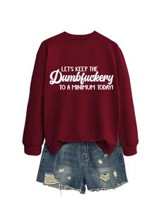 Burgundy sweatshirt with white slogan text paired with distressed blue denim shorts