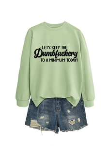 Mint green sweatshirt with slogan print paired with distressed denim shorts