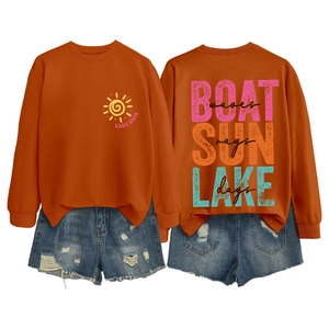 Detailed back view of Boat Sun Lake printed orange sweatshirt and ripped denim shorts