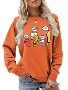 Detail of the bright orange crewneck sweatshirt featuring colorful cartoon graphic prints