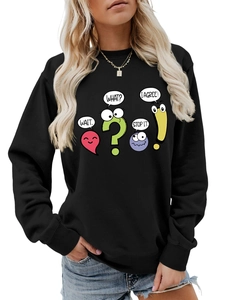 Detailed close-up of cartoon graphic print on black crewneck sweatshirt with blue jeans