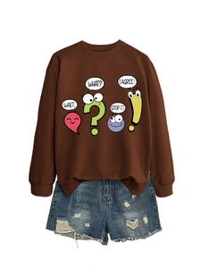 Detail of brown graphic sweatshirt with cartoon text and distressed denim shorts with fringe