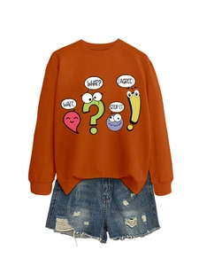 Detail of orange crewneck sweatshirt with cartoon print and distressed blue denim shorts