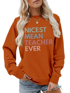 Detail of deep orange sweatshirt showing Nicest Mean Teacher Ever colorful slogan