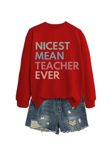 Flat lay of red sweatshirt with Nicest Mean Teacher print and distressed denim shorts