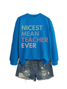 Flat lay of royal blue teacher sweatshirt with distressed denim shorts on white background