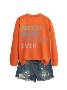 Detail of orange sweatshirt featuring Nicest Mean Teacher Ever colorful printed text