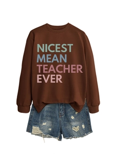 Detail of brown cotton sweatshirt with Nicest Mean Teacher Ever print and ripped denim shorts