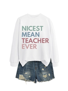 Detail of white sweatshirt with NICEST MEAN TEACHER print and distressed denim shorts