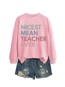 Flat lay detail of pink sweatshirt and denim shorts with Nicest Mean Teacher Ever print