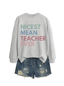Close-up of gray crewneck sweatshirt with colorful Nicest Mean Teacher Ever print