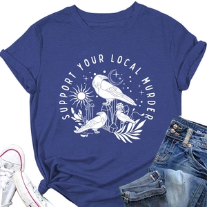 Dettaglio della t-shirt blu con grafica corvo Support Your Local Murder e nodo
