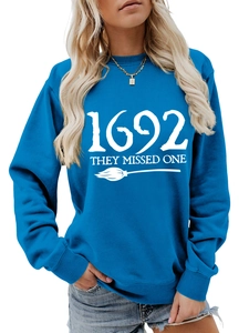 Detail of blue crewneck sweatshirt with 1692 they missed one text and broom print