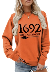 Detail of orange Halloween sweatshirt showing 1692 They Missed One print and ribbed cuffs