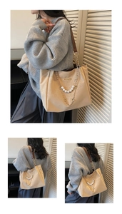 Detail of apricot tote bag with golden metal chain and elegant white pearl decoration