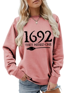 Close-up of the black 1692 they missed one text print and broom on pink sweatshirt
