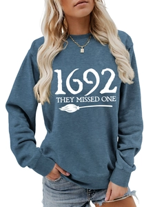 Detailed view of 1692 They Missed One graphic and broom print on navy sweatshirt