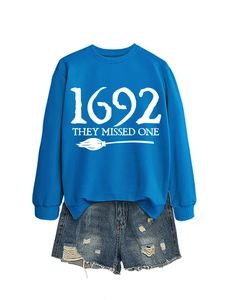 Detail of royal blue crewneck sweatshirt with 1692 they missed one text and broom print