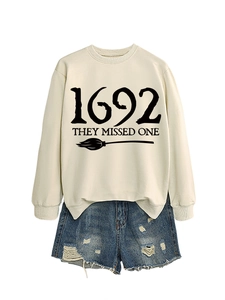 Macro detail of 1692 They Missed One cream sweatshirt with vintage denim shorts set