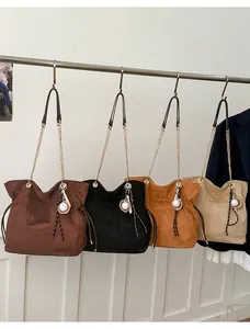 Detail view of large tote bags in four colors with suede texture and baseball charms