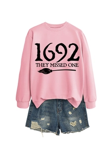 Flat lay of pink 1692 they missed one sweatshirt with distressed denim shorts