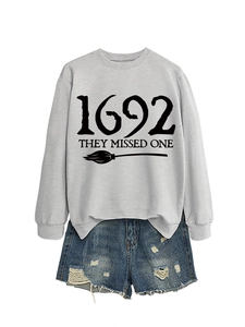 Detail of grey sweatshirt with 1692 text and distressed denim shorts set