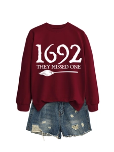Detail of burgundy 1692 witch theme sweatshirt with distressed blue denim shorts