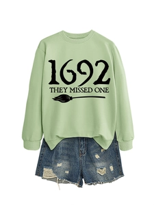 Detail of 1692 They Missed One witch sweatshirt with distressed denim shorts