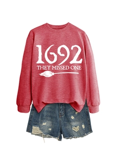 Flat lay of a red 1692 They Missed One sweatshirt and distressed denim shorts