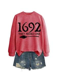 Flat lay of a red long sleeve sweatshirt with 1692 print and distressed denim shorts