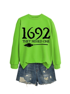 Flat lay of neon green 1692 sweatshirt and distressed denim shorts outfit set
