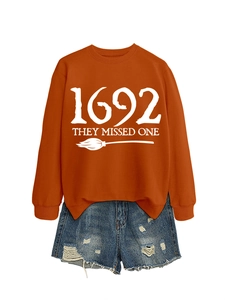 Flat lay of orange 1692 They Missed One sweatshirt and ripped denim shorts set