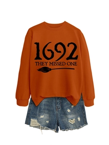 Detail of orange cotton sweatshirt with 1692 print and ripped denim shorts on white background