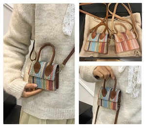 Detail of mini straw woven bag featuring colorful stripes and brown leather strap