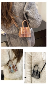 Detailed view of woven straw handbags featuring three color patterns and detachable straps