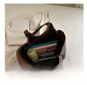 Top view of large brown leather tote bag interior showing ample storage space for daily items