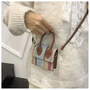 Macro detail of the colorful woven straw texture and premium brown leather handle