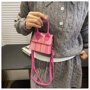 Detail of mini woven handbag in pink and orange gradient with leather shoulder strap