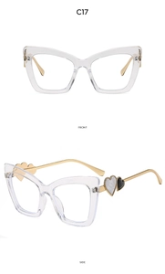 Detail view of transparent cat eye frames with gold metal temples and heart accents