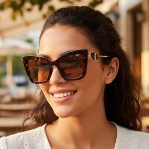 Fashionable tortoise cat eye sunglasses with gold hollow heart detail on temples