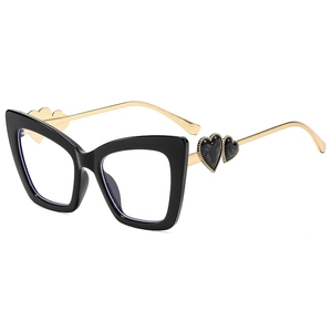 Chic black cat eye glasses with gold metal temples and heart accents on white background