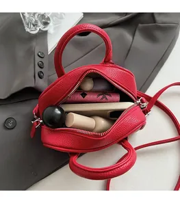 Top-down view of open red pebble leather handbag showing spacious interior for essentials