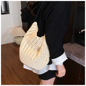 Detail of hollow-out crochet knit shoulder bag with intricate woven texture and pattern