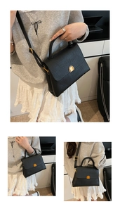 Détail du sac à main noir en cuir grainé avec fermoir doré et bandoulière réglable