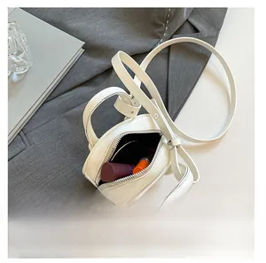 Capacity detail of white leather mini bag holding lipstick and a mirror