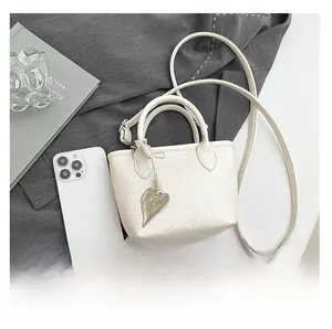 Mini cream bucket bag size comparison with smartphone showing compact dimensions