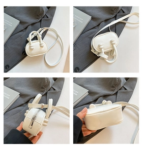 Macro detail of a white mini square handbag showing cylinder handles and metallic zipper