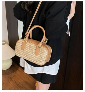Close-up of the woven texture and leather details on the stylish tan crossbody bag
